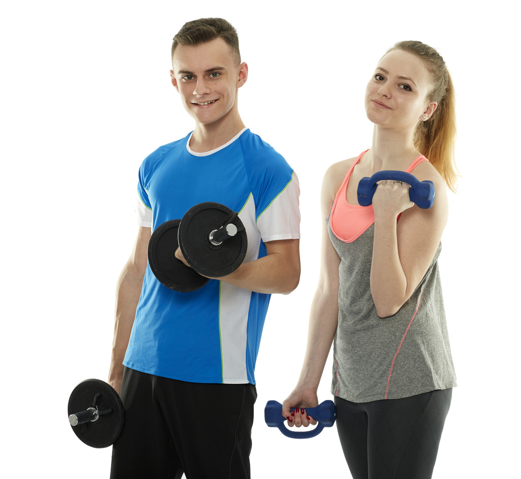 Teenagers working out with dumbbells - Photo, Image