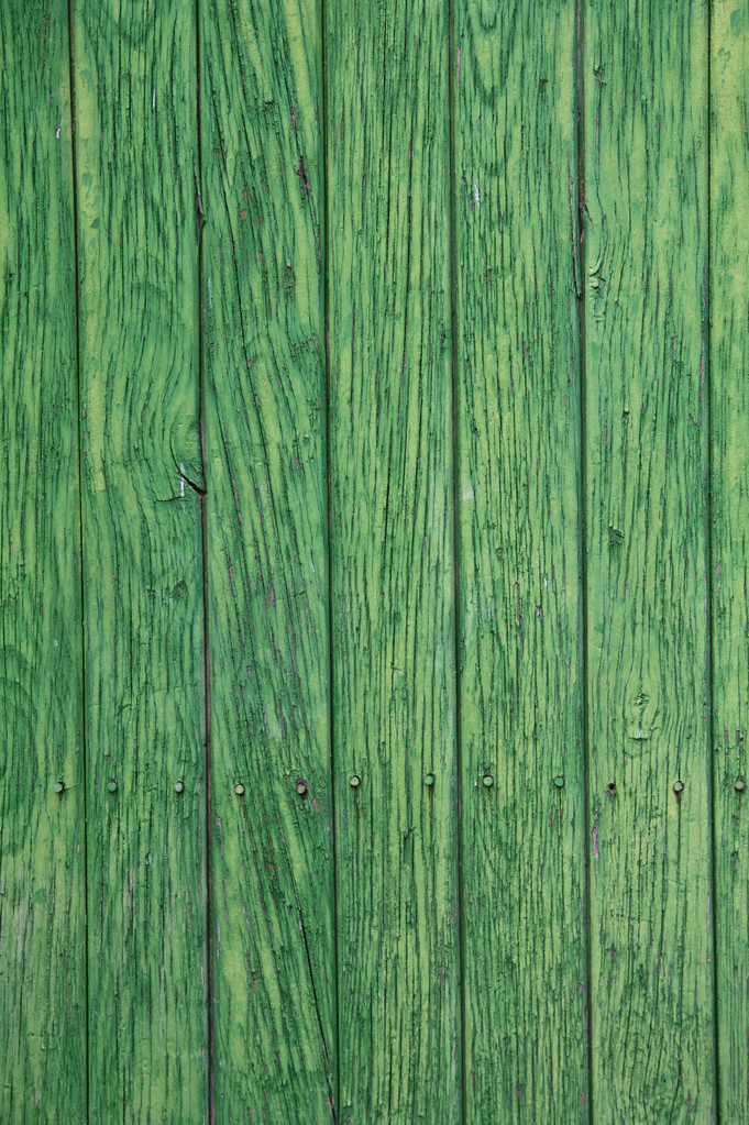 Green paint peeling from a wooden panel door. Aged texture - Photo, Image