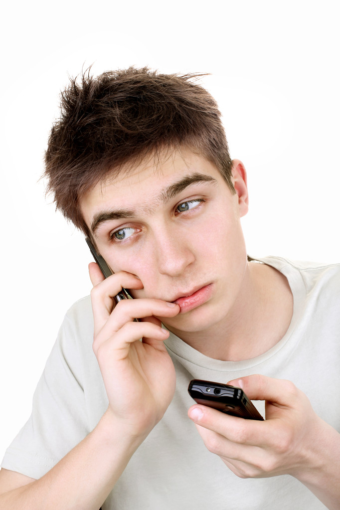 Sad teenager with two phones - Photo, Image