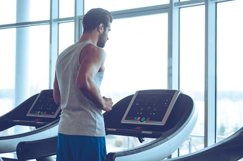 Young man on treadmill - Photo, Image