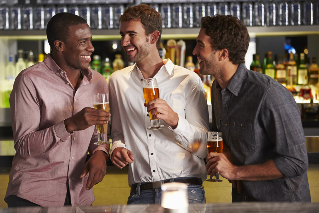 Tres amigos varones disfrutando de las bebidas en el bar
 - Foto, Imagen