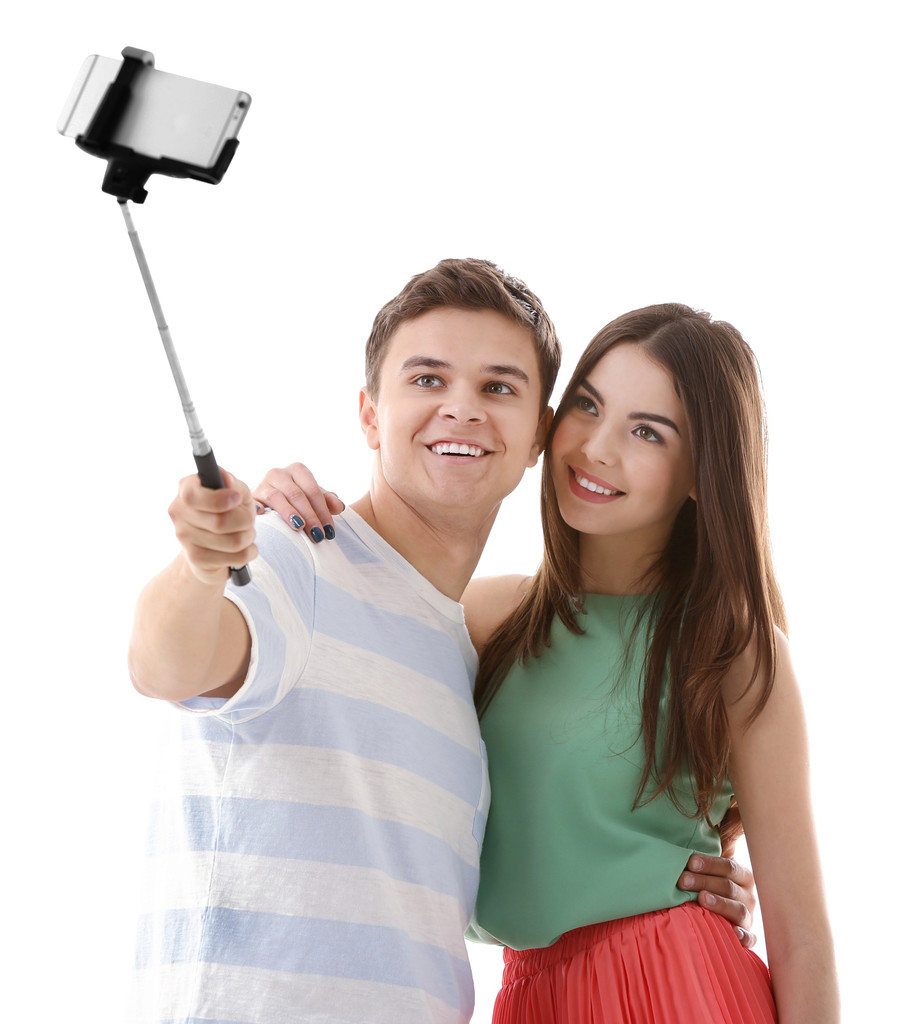 Teenager couple making photo by their self with mobile phone, isolated on white - Photo, Image