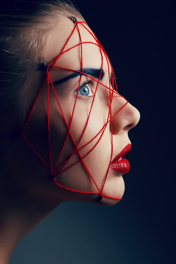 Studio beauty portrait of youg woman with red web on face - Photo, Image