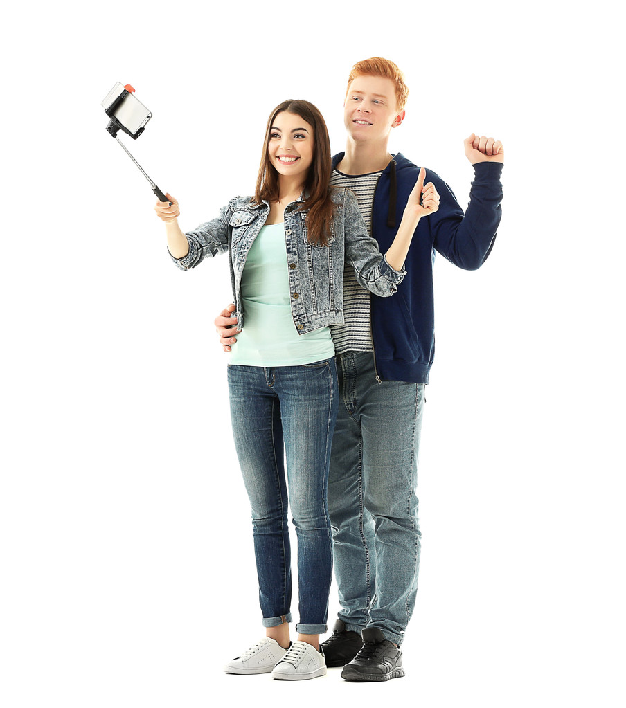 Teini pari tekee valokuvan itse matkapuhelimella, eristetty valkoinen
 - Valokuva, kuva