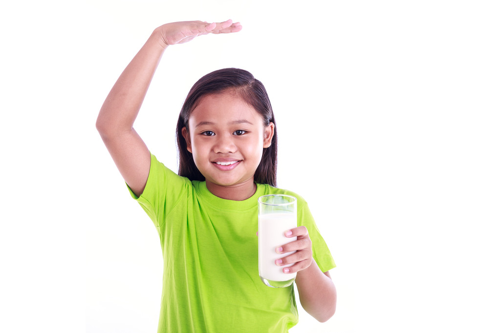 Portrait of young Asian girl holding milk glass isolated on whit - Photo, Image