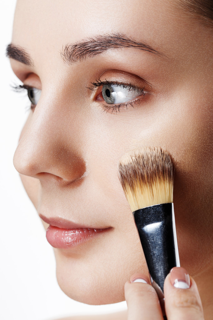 Closeup view of face of Beauty Girl with Makeup Brushes. Natural - Photo, Image