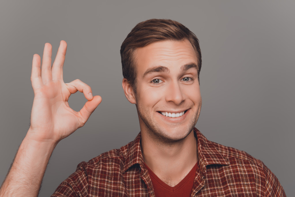 Cheerful young businessman with beaming smile gesturing "OK" - Photo, Image