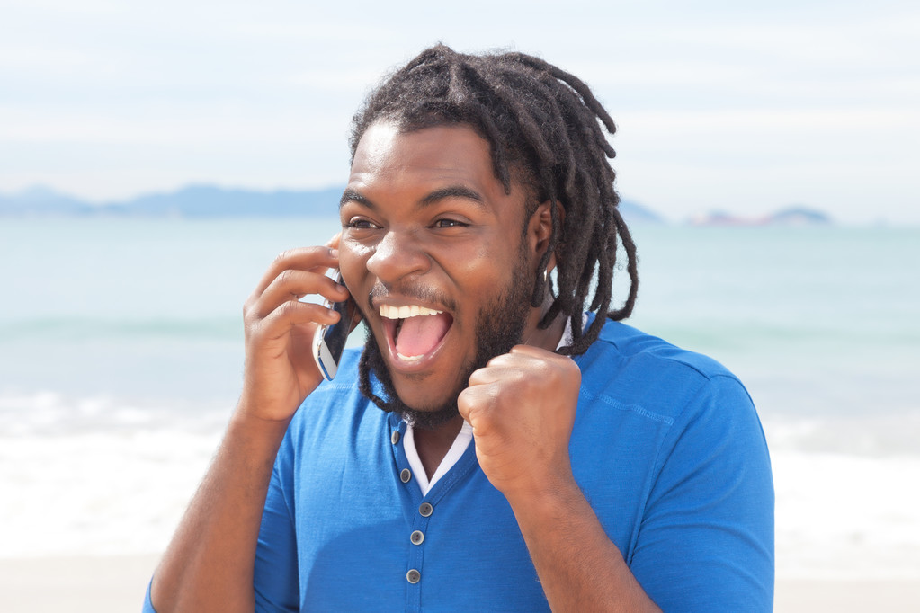 Захватывающий африканский американец с дредами за телефоном
 - Фото, изображение