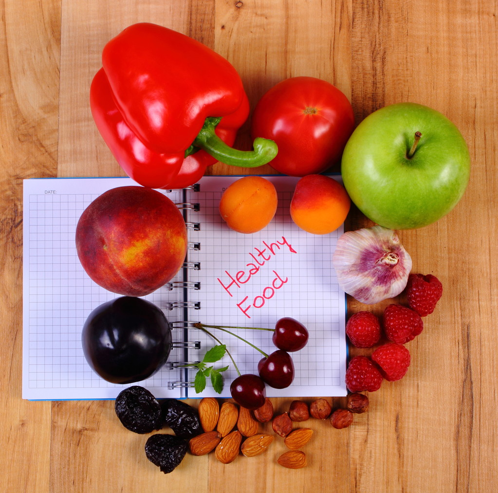 Fruits and vegetables with notebook, slimming and healthy food - 写真・画像