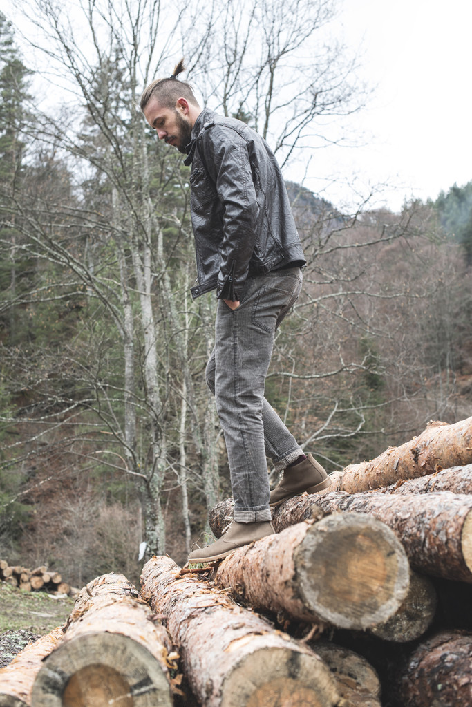 homem em logs na floresta
 - Foto, Imagem