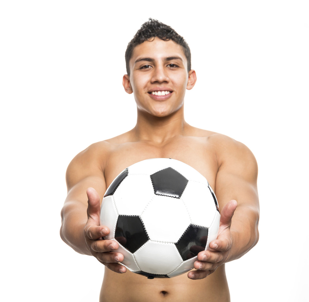 Healthy muscular young man with soccer ball his arms on white ba - Photo, Image