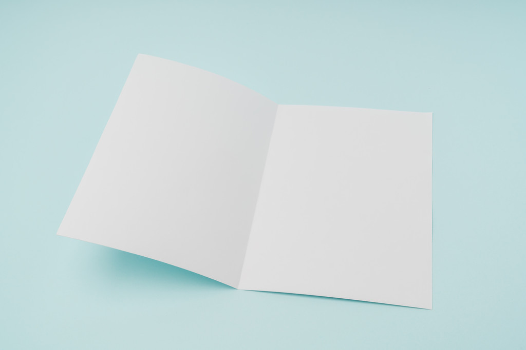 Bifold white template paper on blue background . - Photo, Image