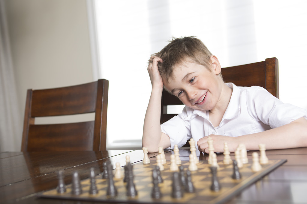 boy playing chess at home - Photo, Image