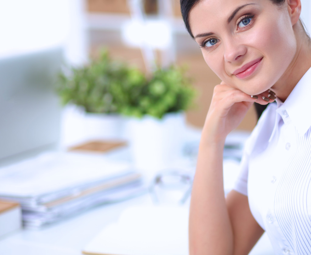 Attractive businesswoman sitting  in the office - Photo, Image