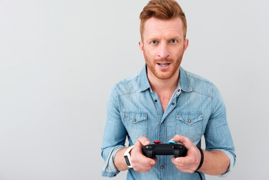 Cheerful man playing video games - Photo, Image