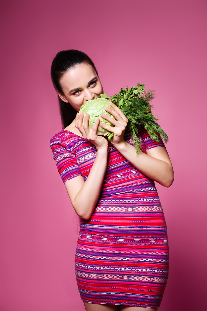 όμορφο, χαρούμενο κορίτσι με λάχανο και μαϊντανό στο στούντιο  - Φωτογραφία, εικόνα