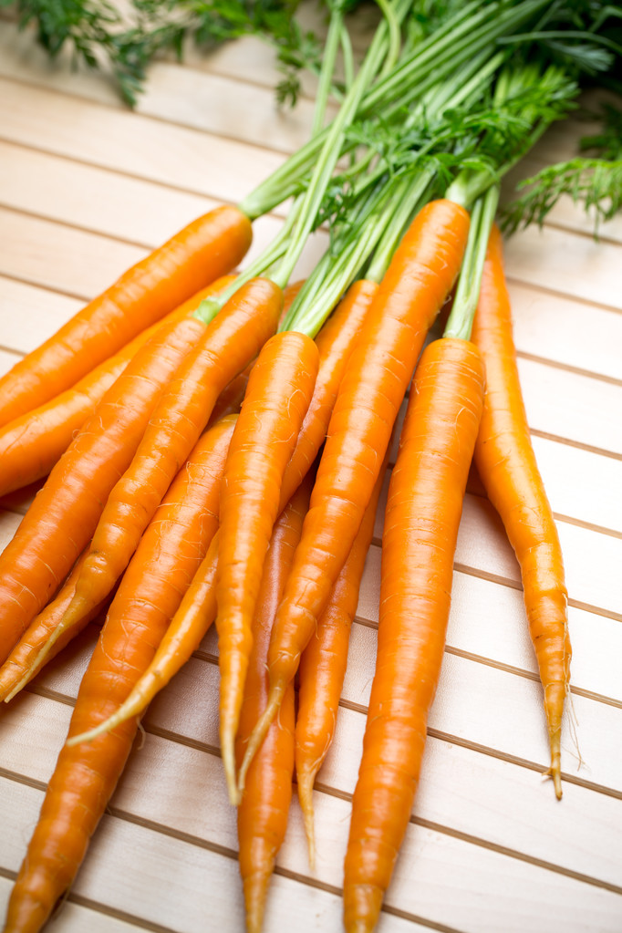 Fresh carrots on the gray backgrounds. - Photo, Image