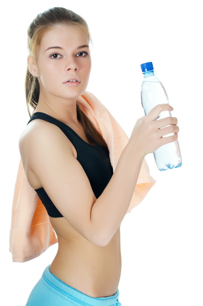 sportovní dívka s ručníkem a láhev s vodou - Fotografie, Obrázek