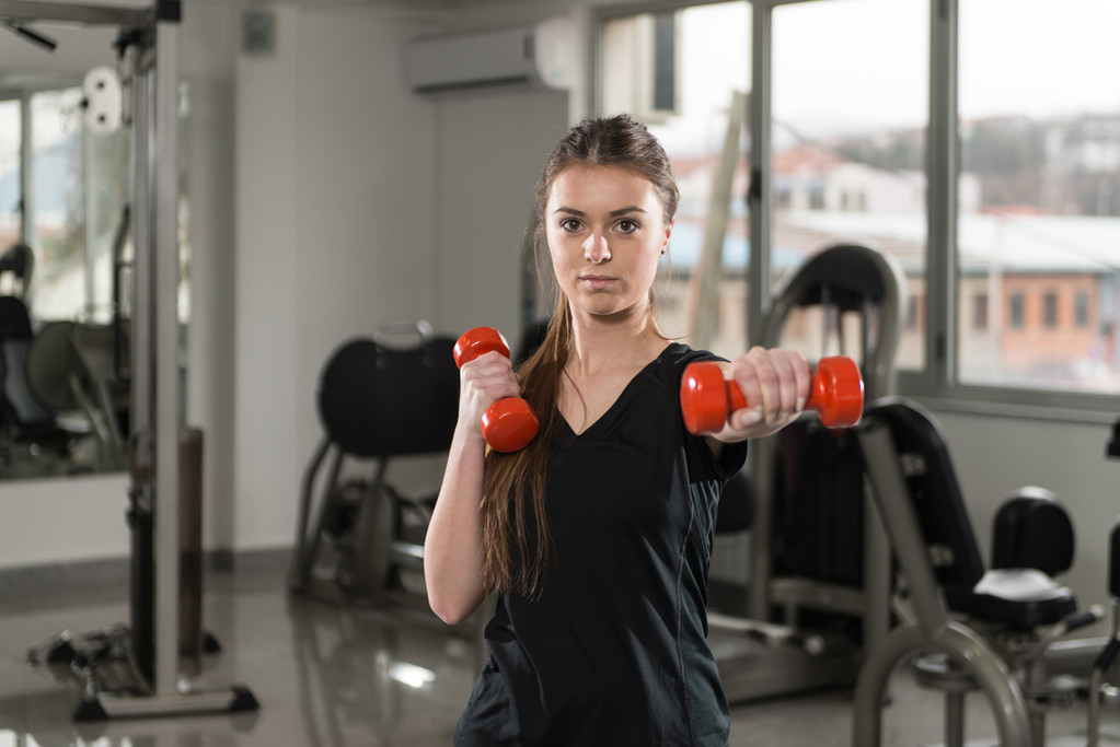 Retrato de una mujer bonita haciendo ejercicio con pesas
 - Foto, Imagen