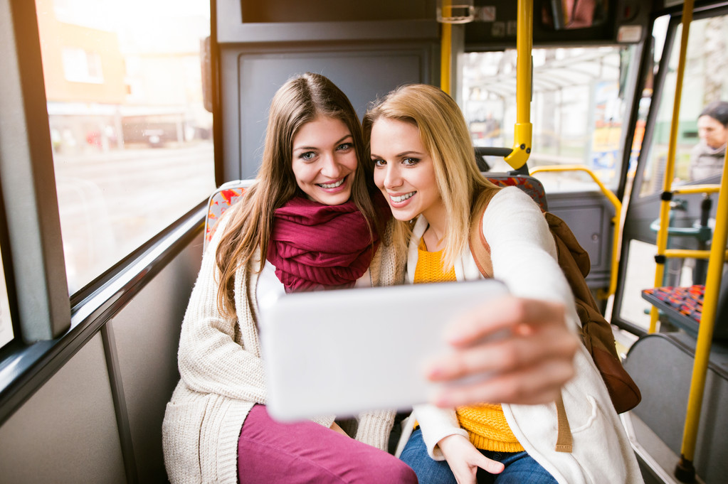 Belle giovani donne che viaggiano in autobus, prendendo selfie
 - Foto, immagini
