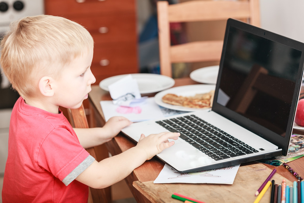 Little boy with laptop on table in home. - Photo, Image