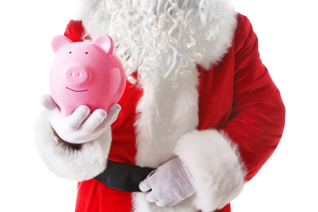 Santa Claus hand holding piggy bank on white background - Photo, Image