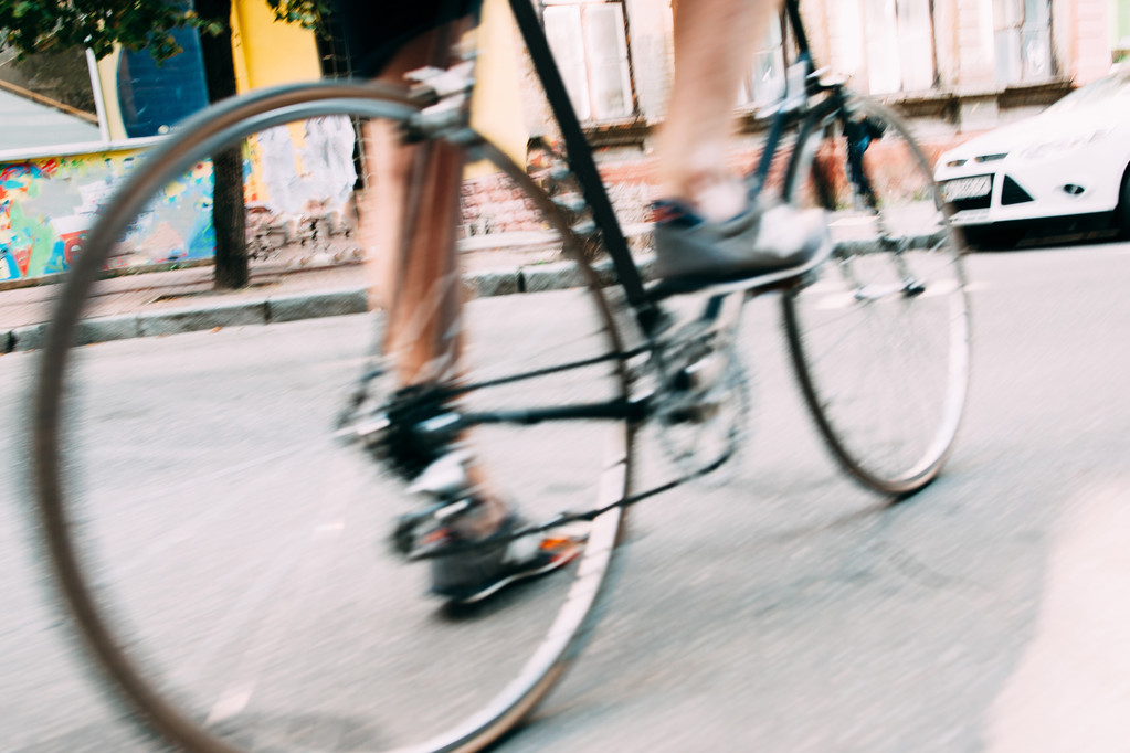 Blurry photo of male legs on bicycle - Photo, Image