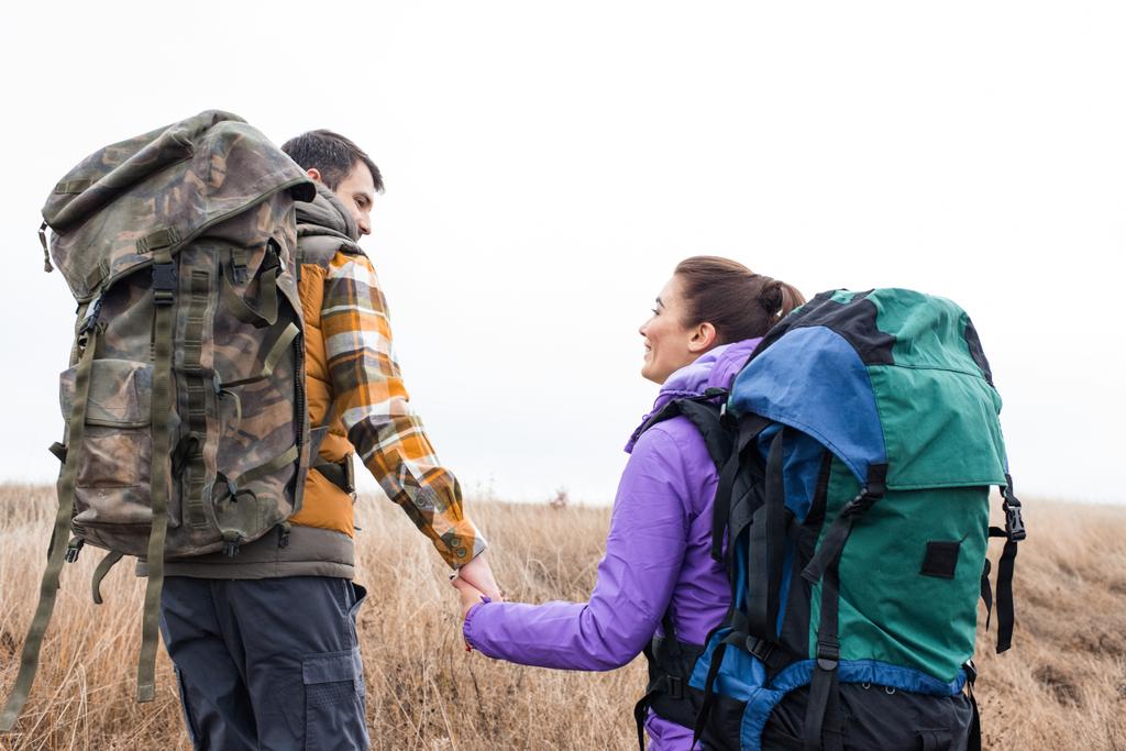 Young couple with backpacks holding hands - Photo, Image