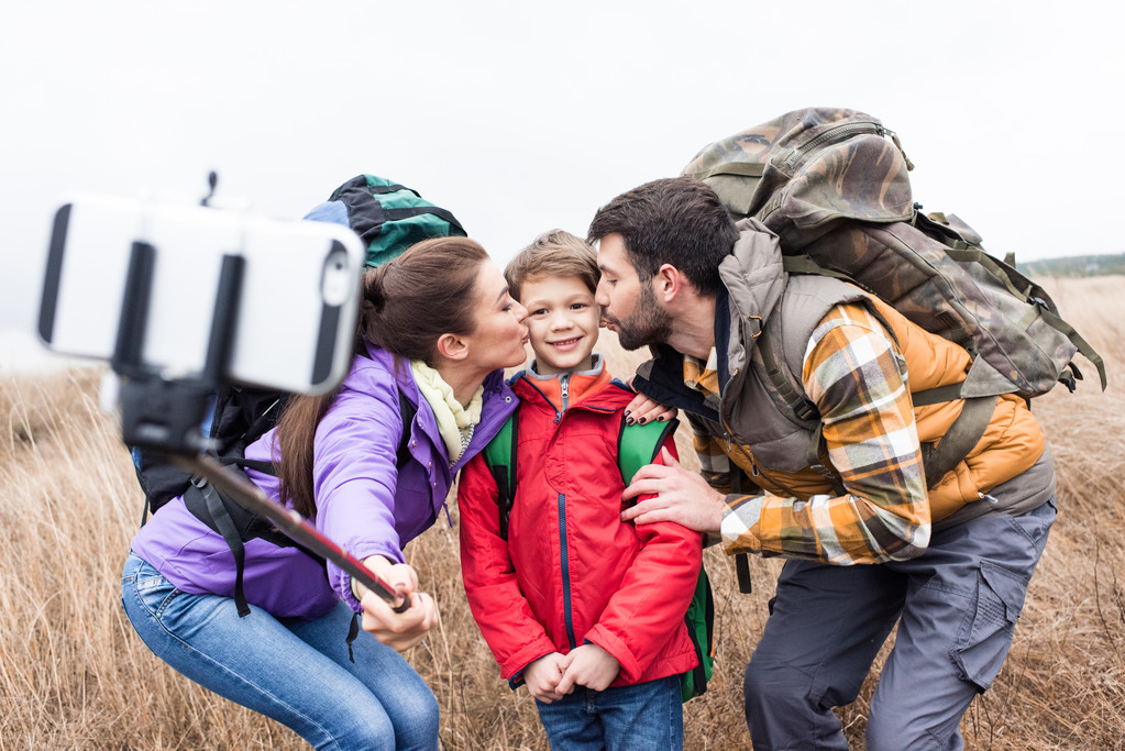 Happy family with backpacks taking selfie - Fotografie, Obrázek