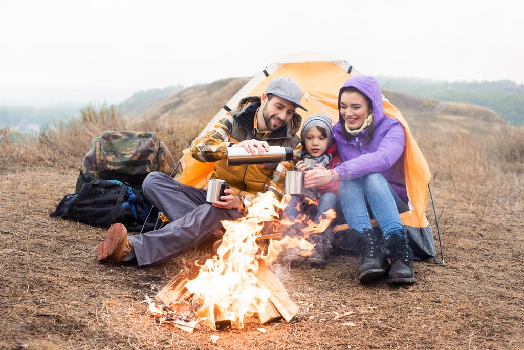 Family drinking tea near burning fire - Fotografie, Obrázek
