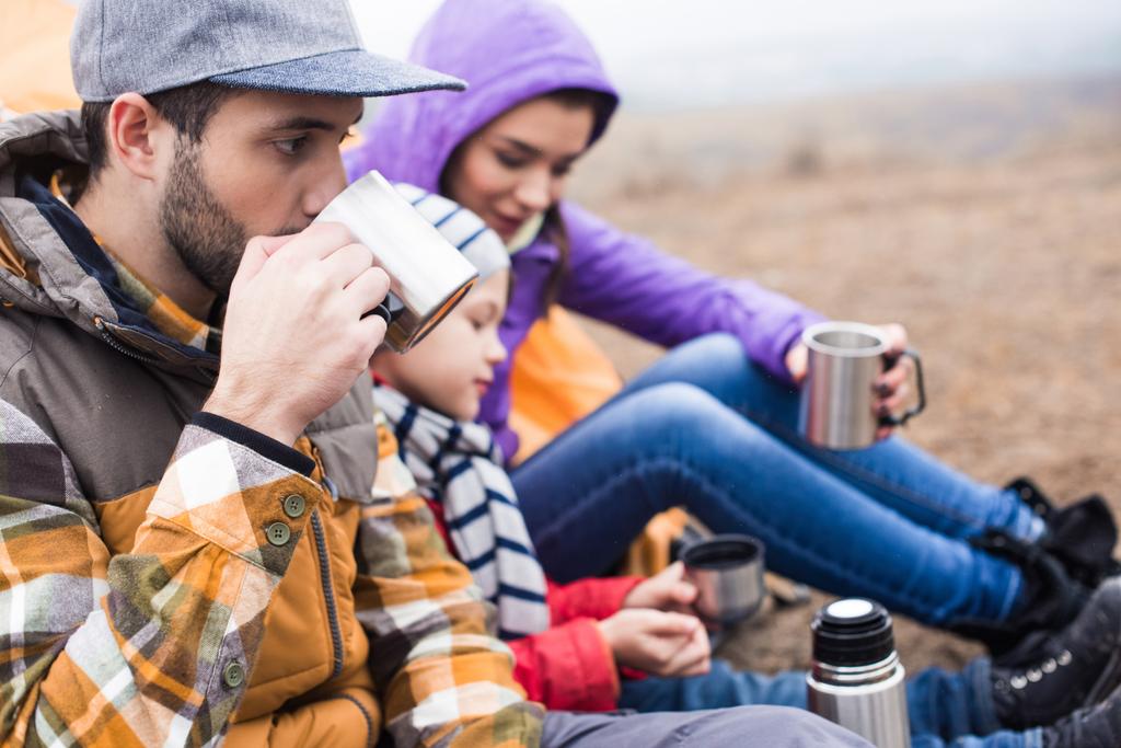 Family drinking tea from metal cups - Photo, Image