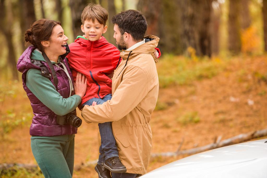 Happy family near car in forest - Φωτογραφία, εικόνα