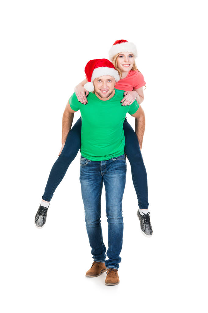 felice coppia in rosso cappelli di Natale
  - Foto, immagini