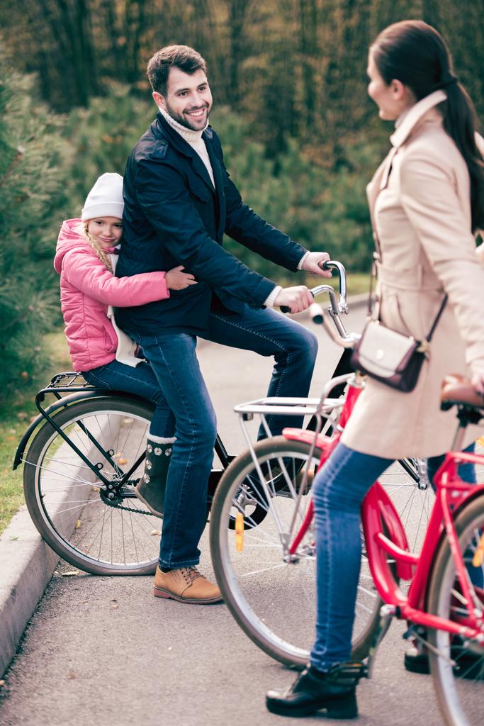Cheerful family standing with bicycles  - Photo, Image