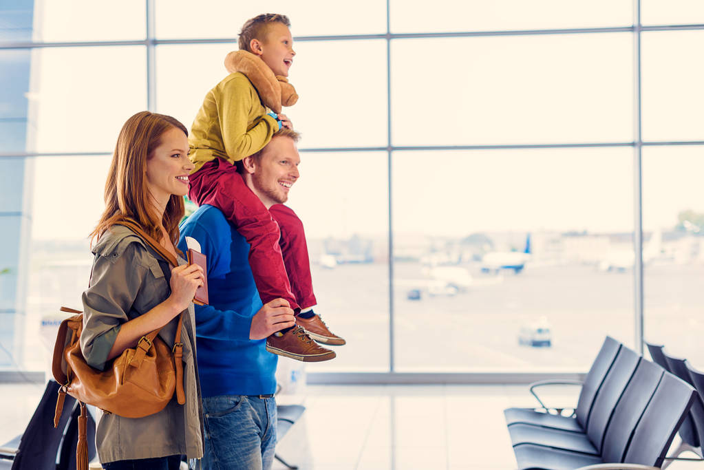 Gelukkige familie met koffer in luchthaven - Foto, afbeelding