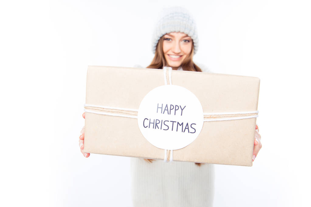 Cheerful woman  in warm hat and scarf holding package and congra - Photo, Image