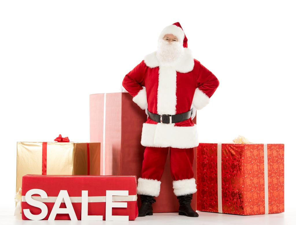 Papai Noel de pé com sinal de venda
  - Foto, Imagem