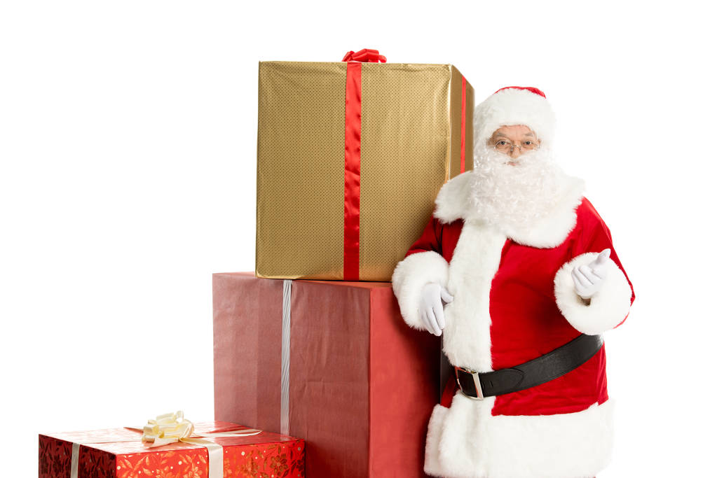 Papai Noel com pilha de presentes de Natal
 - Foto, Imagem