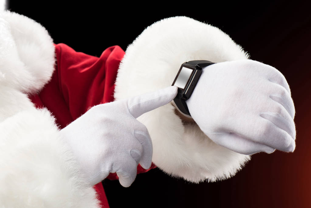 Papá Noel señalando el reloj inteligente
 - Foto, imagen
