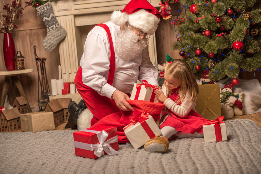 Weihnachtsmann zeigt Weihnachtsgeschenke - Foto, Bild