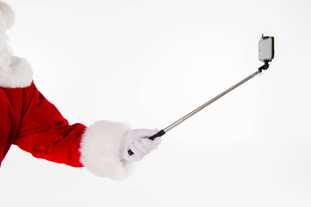 Joulupukin käsi osoittaa selfiestick
 - Valokuva, kuva