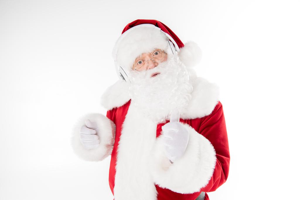 Papai Noel ouvir música com fones de ouvido
 - Foto, Imagem