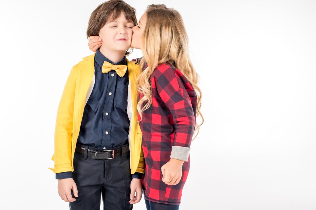 Schoolgirl kissing in cheek schoolboy - Photo, Image