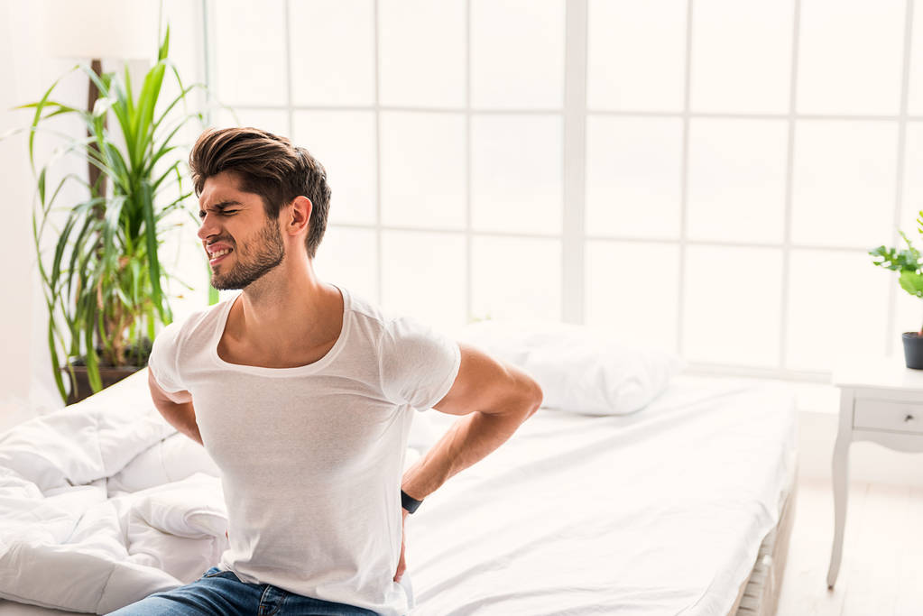 Frustrated guy feels pain in back - Photo, Image