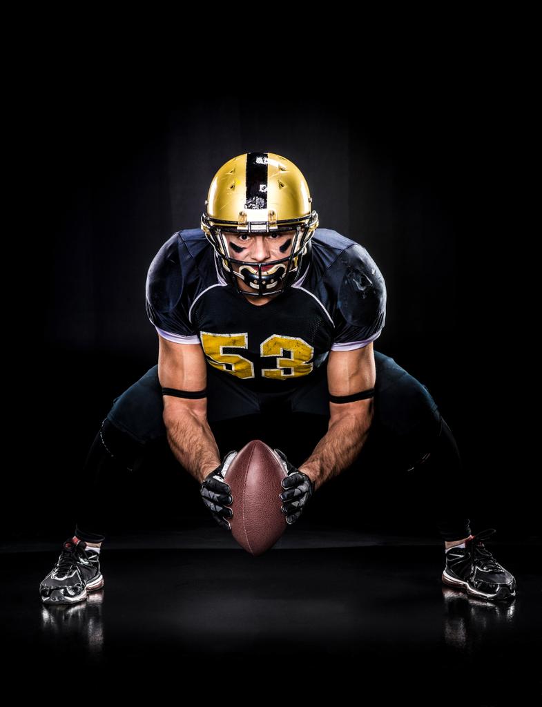 American football player holding ball  - Photo, Image