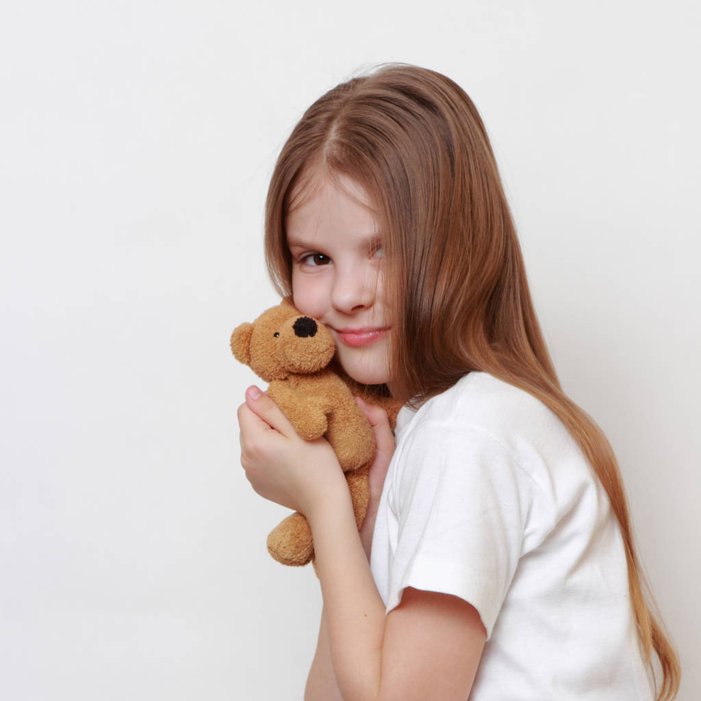 Adorable little girl holding toy teddy bear - Photo, Image
