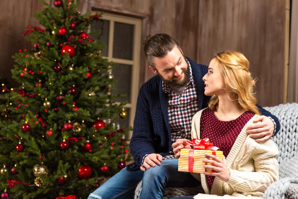 Couple sitting with christmas present  - Photo, Image