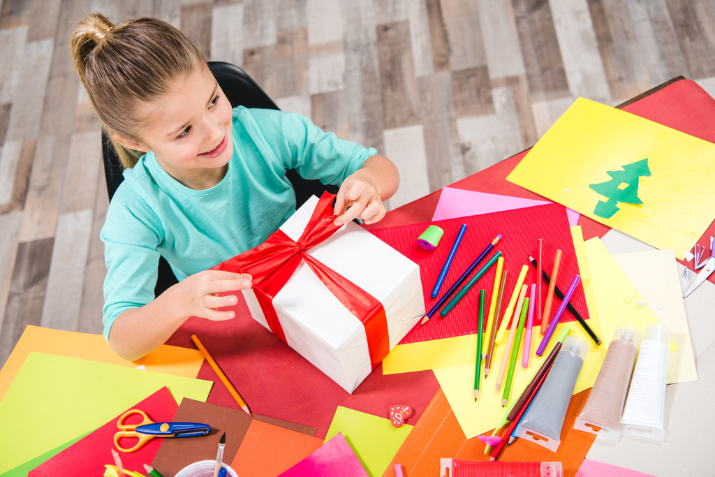 Schoolchild wrapping gift box  - Photo, Image