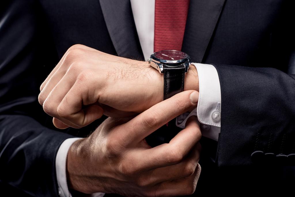 Businessman checking wristwatch - Photo, Image