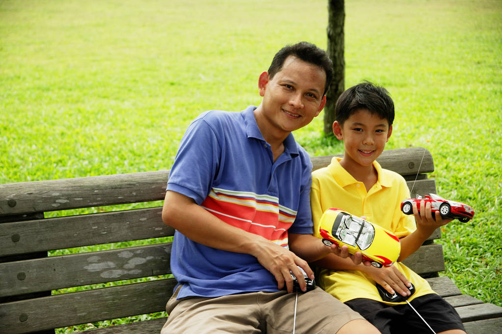 Father and son holding remote control cars - Photo, Image